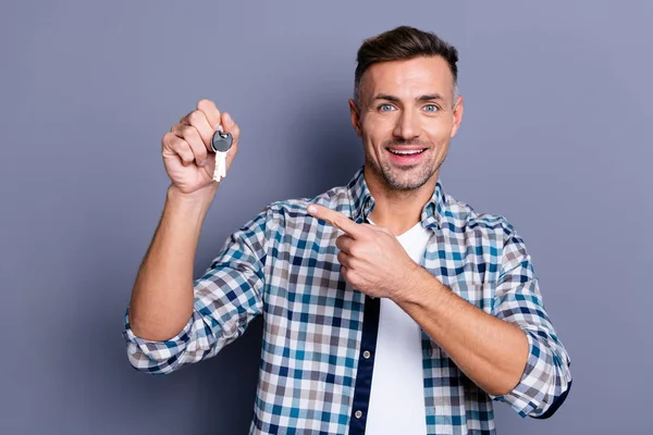 Close up photo handsome he him his guy arms hands holding key chain broker agent salesperson excited sale discount price professional wear casual plaid checkered shirt isolated grey background — Stock Photo, Image