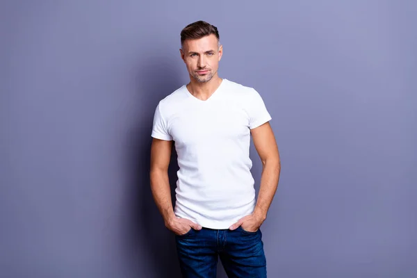 Close up photo amazing he him his middle age macho perfect appearance easy-going reliable person hands arms pockets wear casual jeans denim pants trousers white t-shirt isolated grey background — Stock Photo, Image