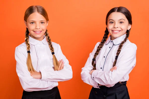 Portrait of nice attractive lovely charming confident cheerful cheery positive pre-teen girls folded arms isolated over bright vivid shine orange background — Stock Photo, Image