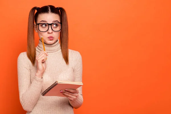 Close up photo beautiful amazing she her lady wondered pretty hairdo look side empty space planner pencil pen hands arms pensive ponder wear casual pastel pullover clothes isolated orange background — Stock Photo, Image