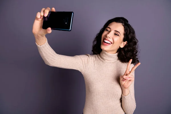 Close up photo attractive beautiful she her lady hold hands arms telephone make take selfies v-sign symbol say hi hello friends wear casual beige pastel sweater pullover isolated grey background — Stock Photo, Image