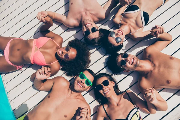High angle photo of charming people lieing on floor smiling wearing eyeglasses eyewear outdoors — Stock Photo, Image