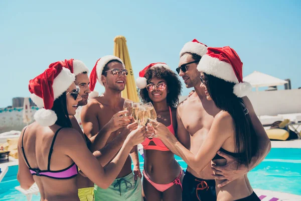 Six multiethnic friends clink glasses celebrating new year at exotic bali resort — Stock Photo, Image