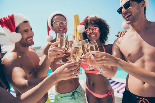 Portrait of cheerful crowd of students toasting wearing santa claus hat eyewear eyeglasses having brunet hair standing outside — Stock Photo, Image