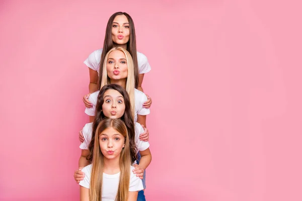 Nice attractive lovely lovable winsome cheerful cheery funny long haired girls relatives building vertical top pyramid sending air kiss embracing isolated over pink pastel background — Stock Photo, Image