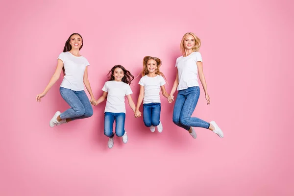 Full length body size view of four nice attractive lovely lovely cute slim fit cheerful cheery long hair girls having fun free spare time spending holiday isolated over pink pastel background — стоковое фото