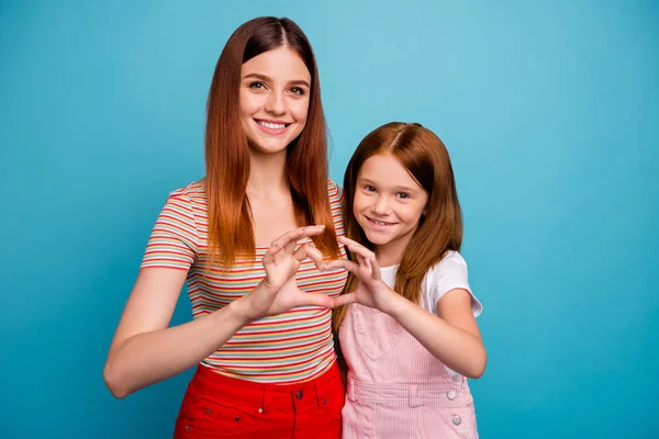 Pretty foxy little lady and her mom making heart figure with help of hands wear casual clothes isolated blue background — Stock Photo, Image