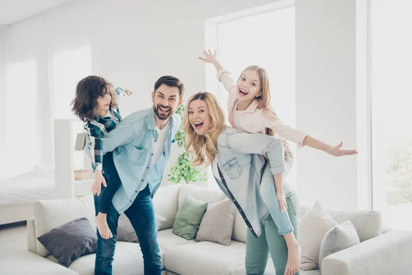 Profile photo of four family members having best free time pretend flight airplane indoors apartments