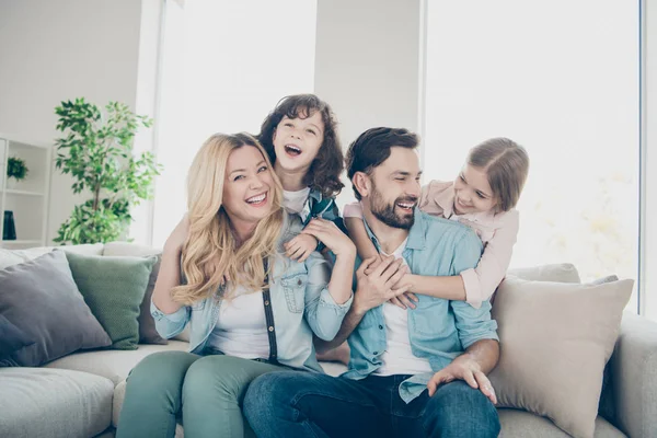 Photo of four family members spend time rejoicing giggle piggy back position sit couch living room — Stock Photo, Image