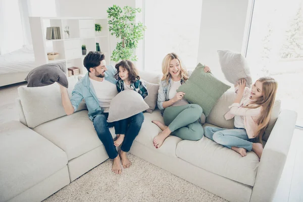 High angle photo of adopted family four members spend free time playing pillows sit couch living room — Stock Photo, Image