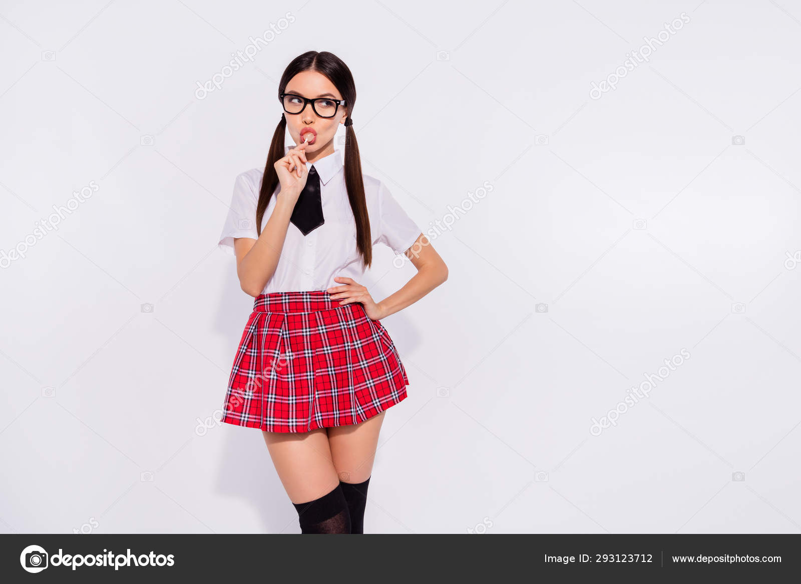 Portrait of her she nice-looking attractive lovely winsome glamorous  alluring enticing girl wearing checked skirt licking lolly lolli pop sweet  isolated on gray light white background Stock Photo by ©deagreez1 293123712