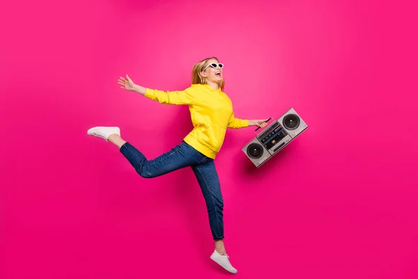 Full body photo of cool lady jumping high with vintage tape recorder wear casual outfit isolated pink background — Stock Photo, Image