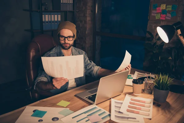 Foto do cara atencioso trabalhar no dia escuro leitura finanças renda papéis desgaste casual roupa sentar escritório moderno — Fotografia de Stock