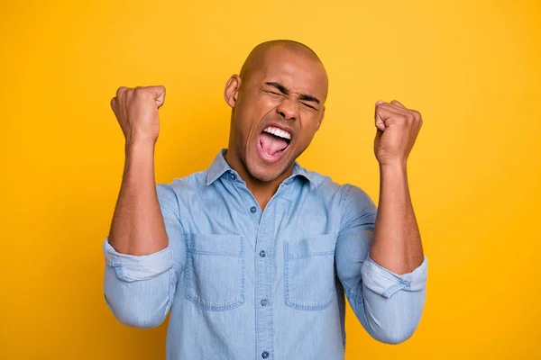 Closeup photo of dark skin guy raise hands yell loud football team win wear jeans denim shirt isolated bright yellow background — Stock Photo, Image