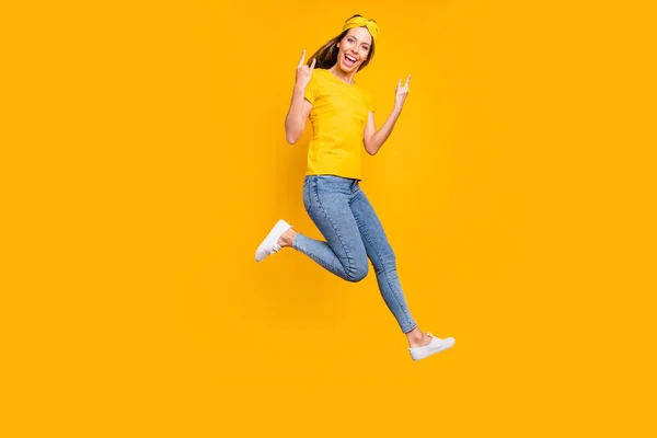 Foto de cuerpo completo de la hermosa dama saltando alto regocijo en concierto de metal desgaste ropa casual aislado fondo amarillo — Foto de Stock