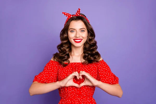Bonita senhora segurando braços na figura do coração expressando cardiologia de segurança desgaste vestido vermelho isolado fundo roxo — Fotografia de Stock