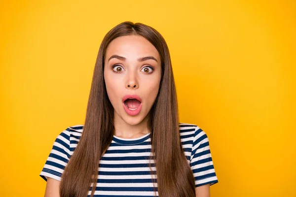 Close up photo of impressed lady with opened mouth shouting looking at camera wearing striped t-shirt isolated over yellow background — Stock Photo, Image