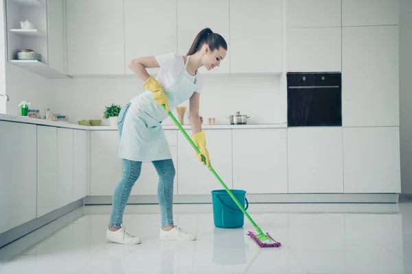 Photo of amazing astonishing girlfriend supporting her mother about cleaning kitchen up while she is lying on bed — Stock Photo, Image