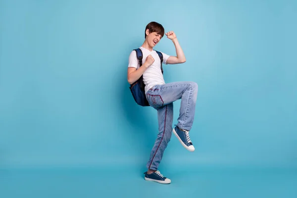 Full length body size photo of dancing rejoicing overjoyed cheerful guy having won olympiad games at math at school while isolated with blue background — Stock Photo, Image