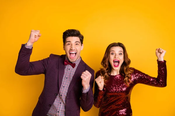 Portrait of his he her she nice-looking attractive lovely gorgeous glamorous cheerful cheery overjoyed people having fun time lucky win winner isolated over bright vivid shine yellow background