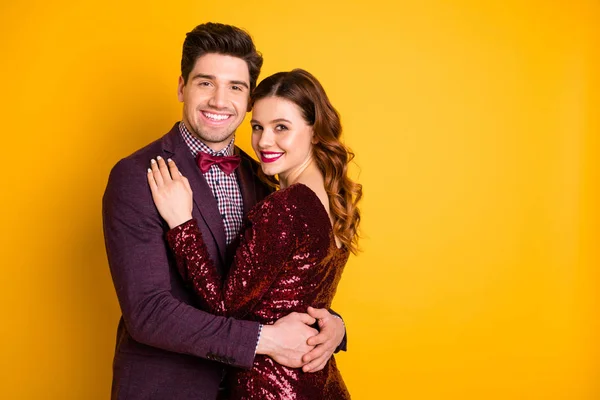 Portrait of his he her she nice-looking attractive lovely smart charming pretty cheerful gentle people cuddling spending festive isolated over bright vivid shine yellow background — Stock Photo, Image