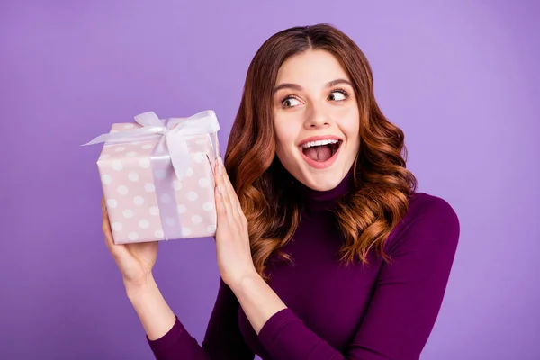 Cerca de la foto de la señora divertida funky sosteniendo paquete de la mano sacudida caja de regalo aislado sobre fondo violeta púrpura —  Fotos de Stock