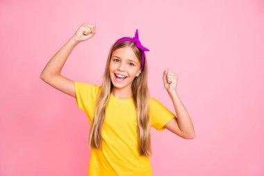 Photo of encouraged ecstatic girl winning some competitions while isolated with pink background clipart