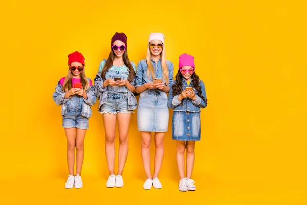 Best friendship lifestyle influencer concept. Full length size photo of four cheerful excited cool modern fancy funky teen people texting letters in social network instagram isolated bright background — Stock Photo, Image