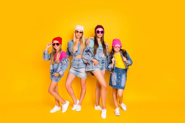 Full body photo of four beautiful attractive pretty charming confident streetstyle denim clothing fans standing isolated over bright shiny background — Photo