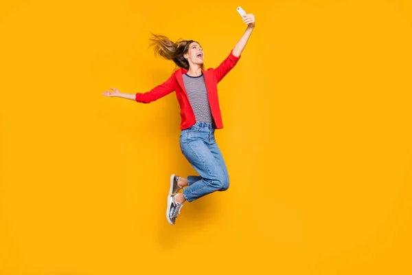 Full storlek foto av härlig tjej hoppar göra bilder skrattade isolerade över gul bakgrund — Stockfoto