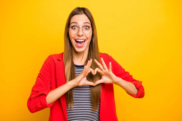 Portrait of nice attractive lovely winsome pretty cheerful cheery glad overjoyed ecstatic straight-haired girlfriend showing healthy heart health care isolated on bright vivid shine yellow background — Stock Photo, Image