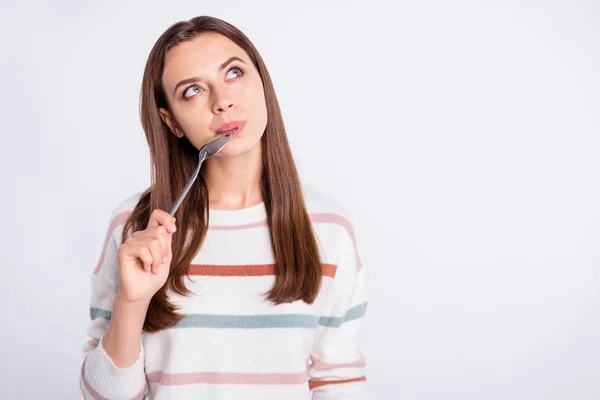 Very hungry lady holding spoon into mouth dream of tasty meal wear striped pullover isolated white background