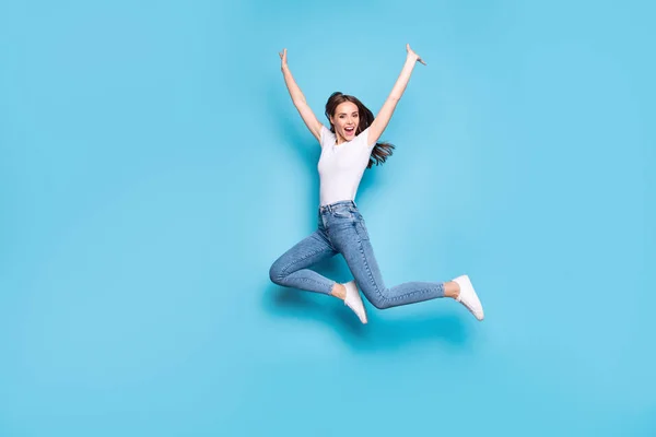 Full body photo of candid person screaming shouting raising hands wearing white t-shirt denim jeans isolated over blue background