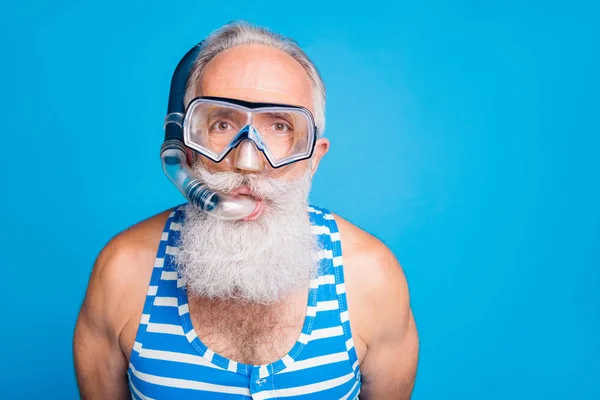 Photo rapprochée d'un retraité funky portant des vêtements de plongée avec tuba et vêtements de bain rayés isolés sur fond bleu — Photo