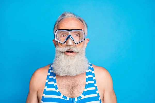 Foto de cerca del anciano impresionado con traje de baño a rayas aislado sobre fondo azul — Foto de Stock