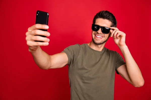 Photo of amazing guy speaking telephone skype wear grey t-shirt isolated on red background