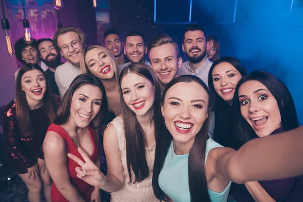 Self-portrait of nice-looking attractive glamorous cheerful positive glad funny funky coquettish adorable ladies and guys having fun rest relax chill out showing v-sign at luxury fogged nightclub