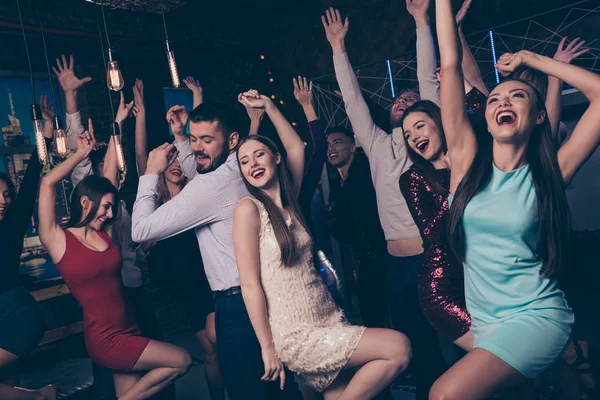 Nice-looking attractive lovely glamorous adorable cheerful positive elegant stylish ladies and gentlemen having fun enjoying festal in fashionable luxury cool nightclub indoors — Stock Photo, Image