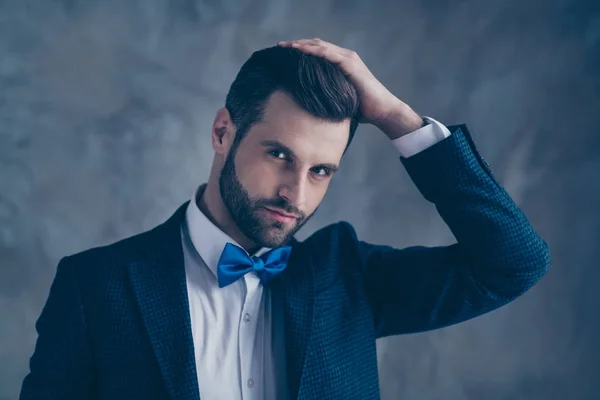 Portrait of luxurious guy touching his hairstyle looking wearing blazer jacket isolated over grey background — Stock Photo, Image