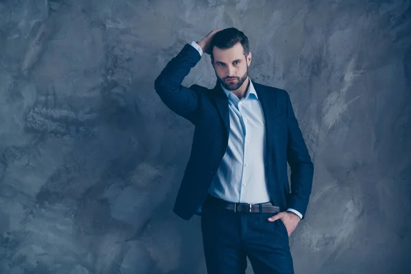 Portrait of masculine guy touching his hairstyle wearing blazer jacket trousers pants isolated over grey background