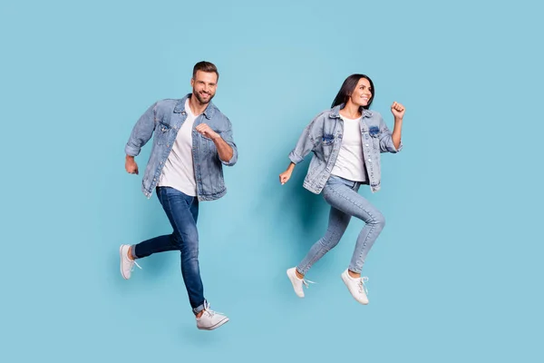 Full length body size photo of beautiful charming gorgeous turned couple with groom fiance running after fiancee while isolated with blue background — Stock Photo, Image