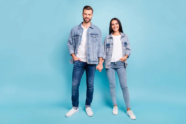 Full length photo of cute people smiling wearing denim jeans jackets isolated over blue background — Stockfoto