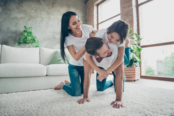 Nice attractive charming lovely sweet adorable cheerful cheery family wearing casual white t-shirts jeans having fun spending free time on carpet floor at industrial loft style interior living-room — Stock Photo, Image