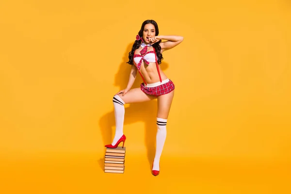 Full length photo of naked tender lady stand book pile prepare private exam boyfriend wear red mini suit isolated yellow background — 图库照片