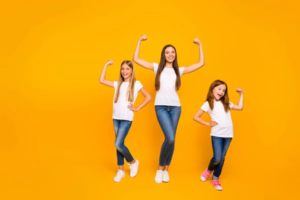 Full length photo of incredible three ladies showing power in arms wear casual clothes isolated yellow background — Stock Photo, Image