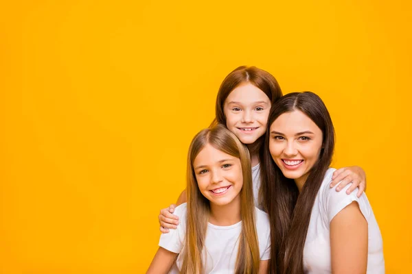 Photo of three amazing ladies of different age hugging wear casual clothes isolated yellow background — Stock Photo, Image