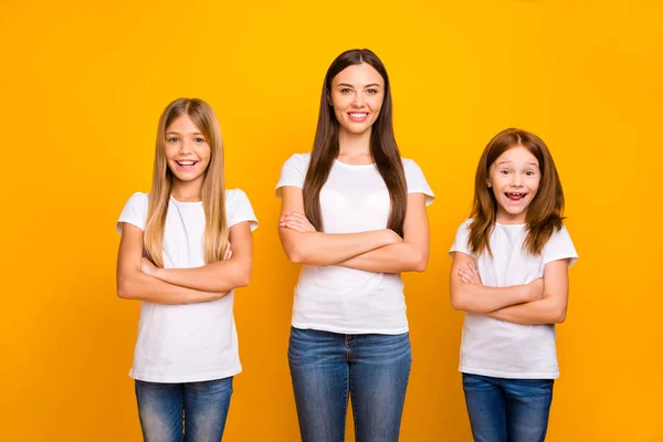 Photo of three sister ladies with crossed arms wear casual white t-shirts isolated yellow background — Stock fotografie