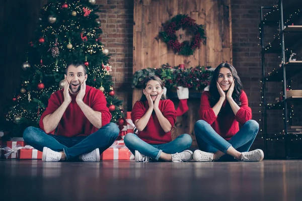 Retrato de três agradável atraente alegre alegre alegre positivo família mãe pai pré-adolescente menina sentado na posição de pose de lótus comemorando o ano novo em decorado industrial loft madeira estilo tijolo interior — Fotografia de Stock