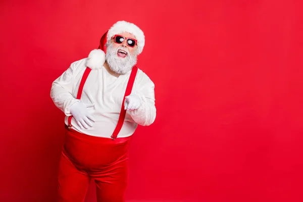 Фото веселой радостной современной прохладной в головном уборе эмоционально громко смеясь над вами, говоря юмористические шутки дедушка рождественская традиция изолированы яркий фон — стоковое фото