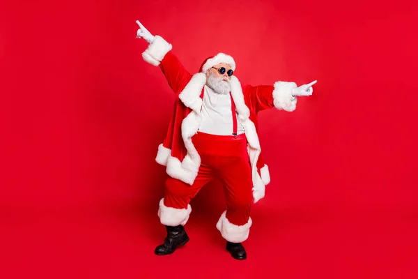 Ganzkörper-Foto von flippigen fetten Weihnachtsmann mit großen lustigen Bauch tanzen erhobenen Armen tragen Stil stilvolle trendige Brille Brille isoliert über rotem Hintergrund — Stockfoto